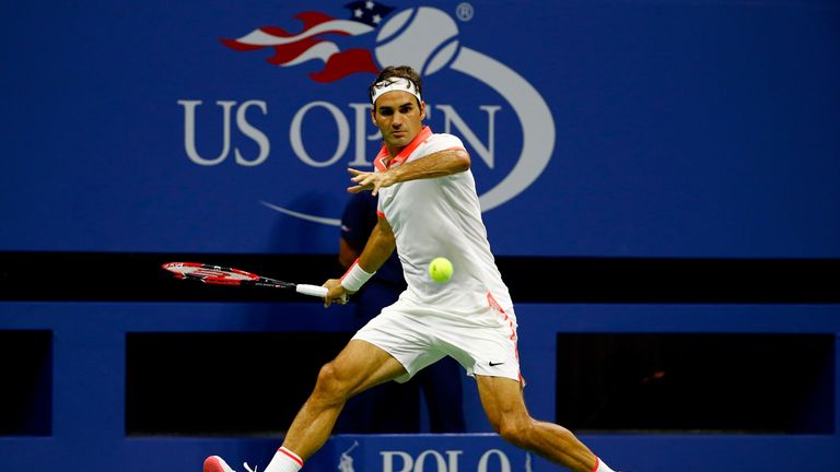 Roger Federer of Switzerland returns a shot against John Isner of the United States at the US Open