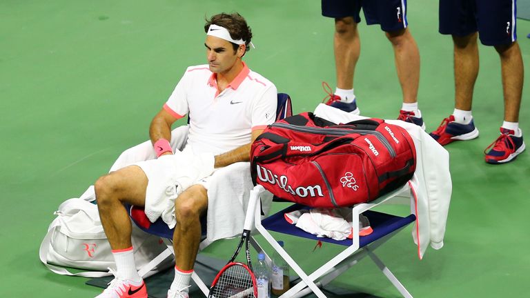Roger Federer looks on from the sidelines during his Men's Final match against Novak Djokovic