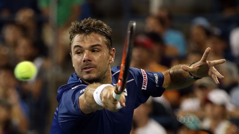 Stan Wawrinka of Switzerland returns a shot to Kevin Anderson of South Africa at the US Open