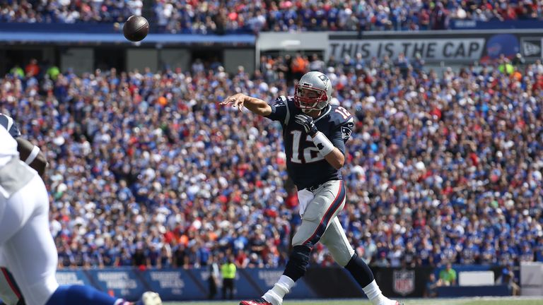 Tom Brady #12 of the New England Patriots throws a touchdown pass during NFL game action against the Buffalo Bills at Ralp