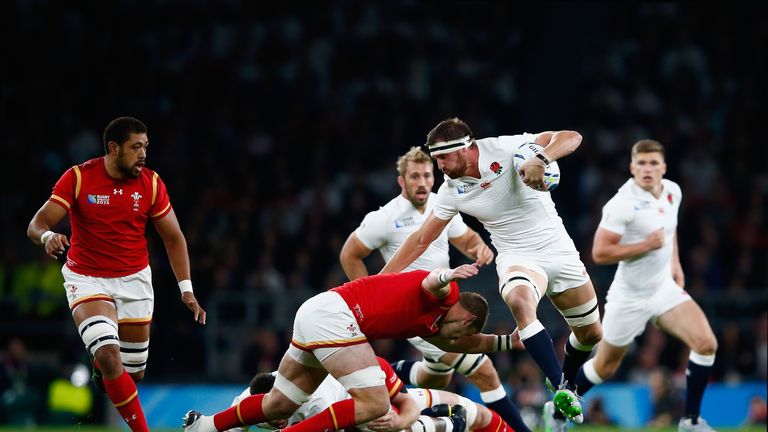 Tom Wood of England attempts to beat the tackle of Dan Lydiate of Wales during the 2015 Rugby World Cup Pool A match at Twickenham