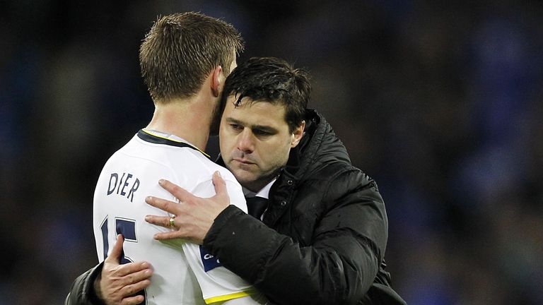 Tottenham's Mauricio Pochettino (R) consoles Eric Dier after the English League Cup Final football match against Chelsea at Wembley Stadium in 2015