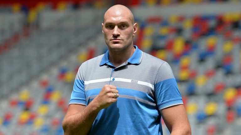 DUESSELDORF, GERMANY - JULY 21:  Tyson Fury poses on the pitch