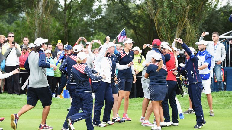 Players and officials of team USA celebrate after winning the singles matches of The Solheim Cup 