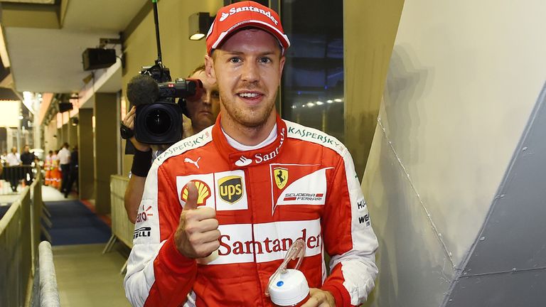 Sebastian Vettel celebrates after landing his first pole for Ferrari in Singapore