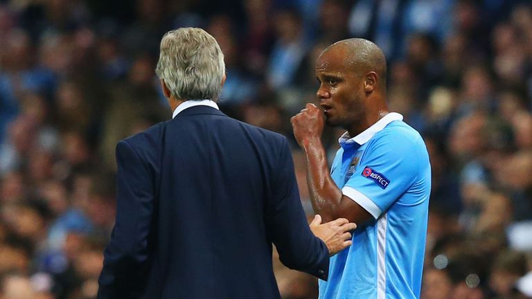 MANCHESTER, ENGLAND - SEPTEMBER 15:  Manuel Pellegrini manager of Manchester City with an injured Vincent Kompany of Manchester City during the  UEFA Champ