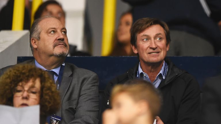 Ice hockey legend Wayne Gretzky (R) looks on from the stand during the Capital One Cup third round match between Tottenham and Arsenal