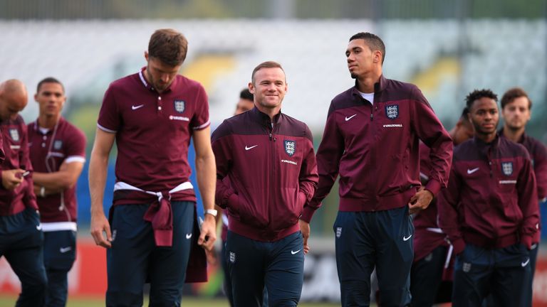 Wayne Rooney takes a stroll with his England team-mates at the San Marino stadium on Friday evening