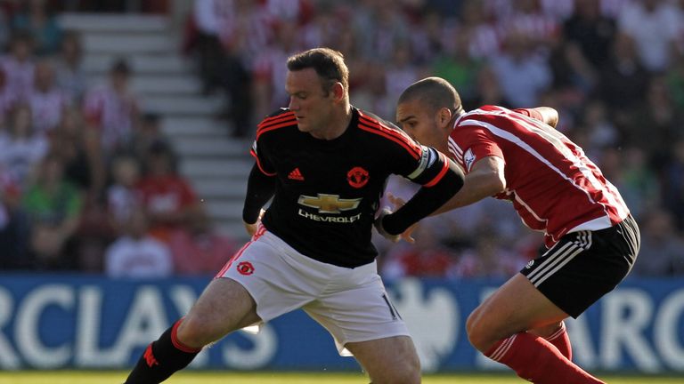 Wayne Rooney holds off Oriol Romeun