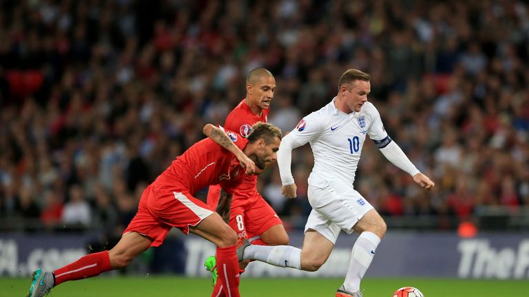 England's Wayne Rooney (right) gets away from Switzerland's Valon Behrami during the UEFA European Qualifier at Wembley Stadium, London