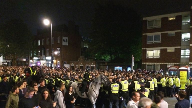  Police control fans outside the stadium after the Capital One Cup third round match between Tottenham Hotspur and Arsenal at White Hart Lane 