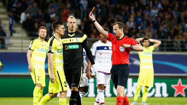 William Collum shows Thomas Foket of Gent a red card during the UEFA Champions League Group H match between KAA Gent and Olympique Lyonnais 