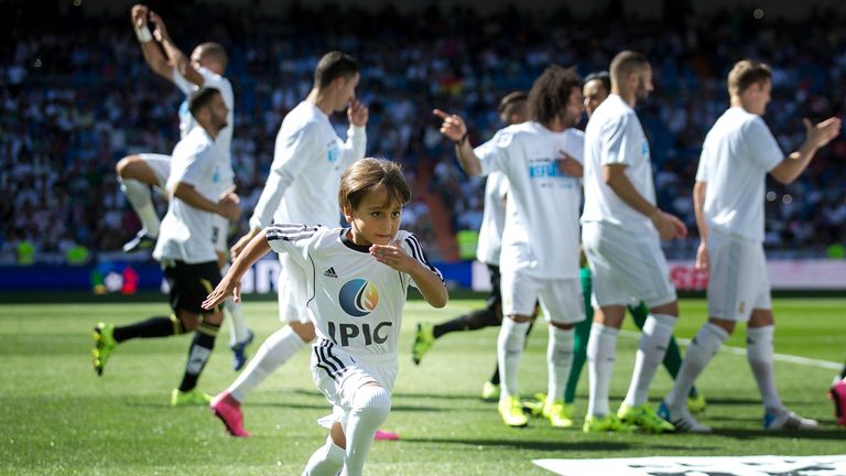 Zied runs off as the Real Madrid players prepare for kick off at the Bernabeu