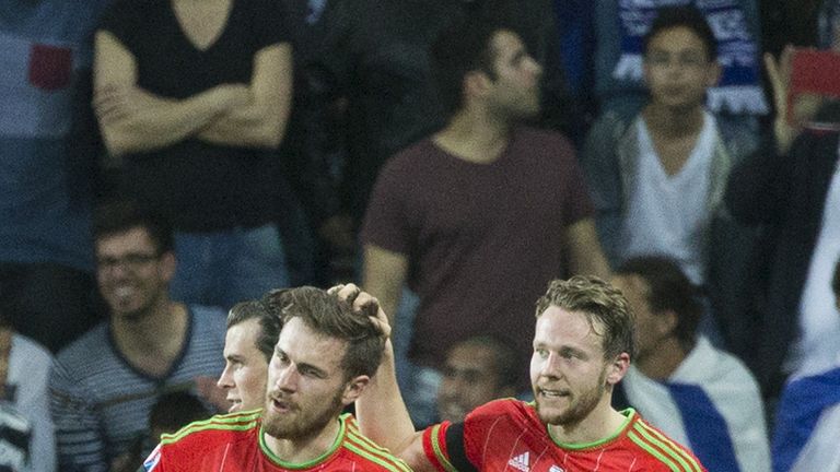 Wales' midfielder Aaron Ramsey (L) is congratulated by his teammate Chris Gunter (R) during the Euro 2016 qualifier between Israel and Wales