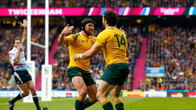 Adam Ashley-Cooper (R) celebrates scoring a try with Matt Giteau against Scotland