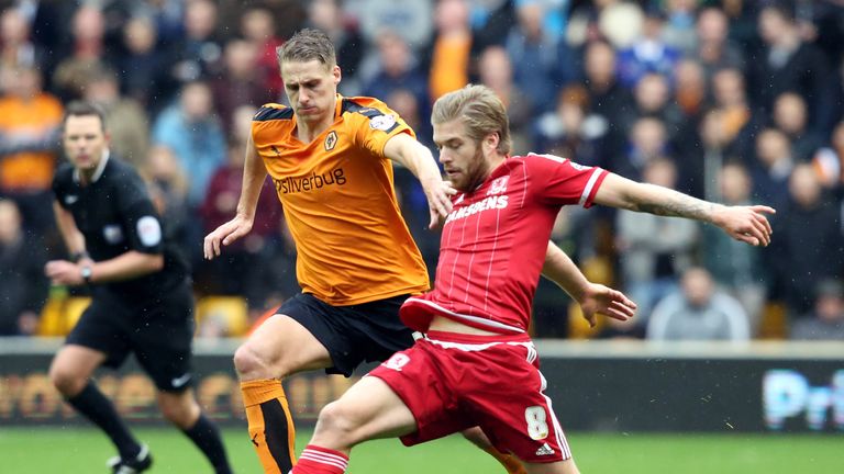 Adam Clayton of Middlesborough shields the ball from Dave Edwards of Wolverhampton Wanderers during the Sky Bet Championship match at Molineux