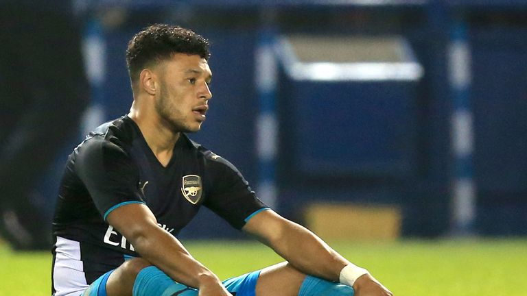 Arsenal's Alex Oxlade-Chamberlain sits injured