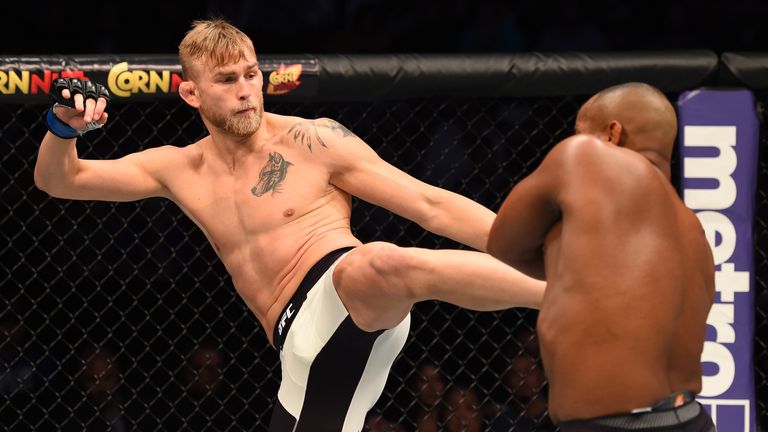 Alexander Gustafsson kicks Daniel Cormier in their UFC light heavyweight championship bout during the UFC 192