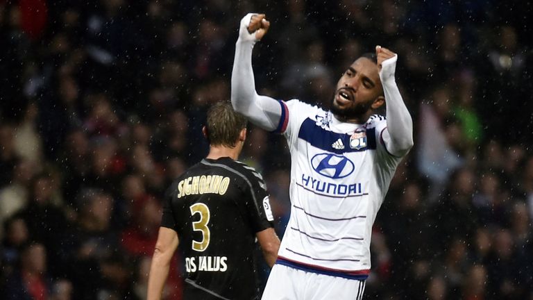 Lyon's French forward Alexandre Lacazette (L) celebrates after scoring a goal during the French L1 football match between Olympique Lyonnais (OL) and Reims