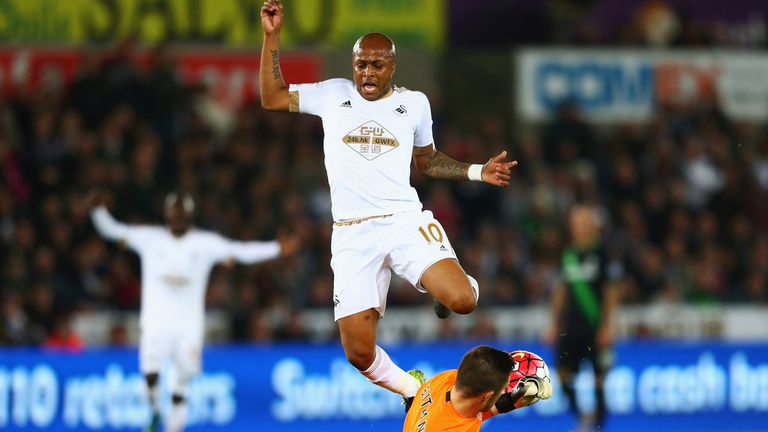 SWANSEA, WALES - OCTOBER 19:  Andre Ayew of Swansea City is challenged by goalkeeper Jack Butland of Stoke City during the Barclays Premier League match be