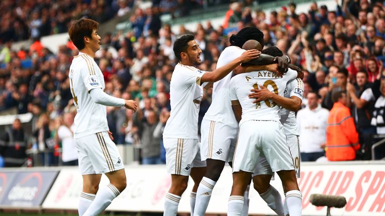 Andre Ayew celebrates with team-mates after putting Swansea 1-0 up against Tottenham