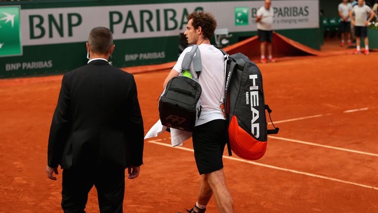 Murray leaves the court as bad weather stops play in the fourth set of the French Open semi-final against Novak Djokovic 