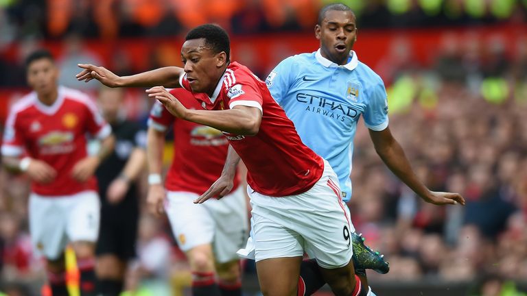 Anthony Martial of Manchester United is challenged by Fernandinho of Manchester City 