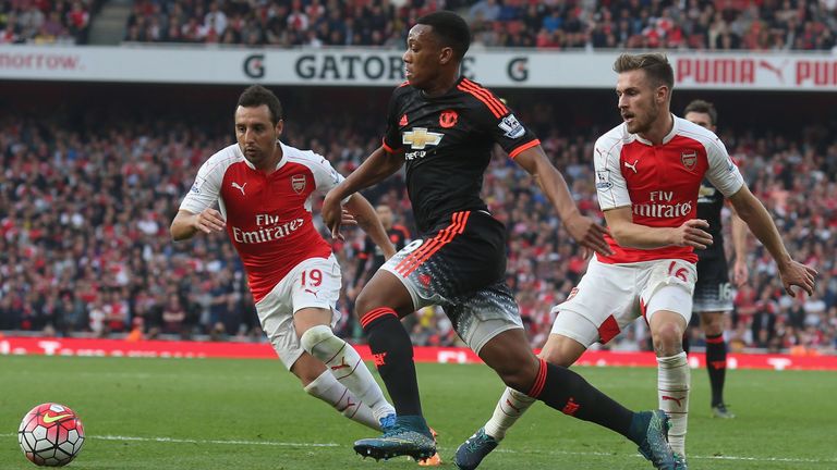 Anthony Martial of Manchester United in action with Santi Cazorla and Aaron Ramsey of Arsenal 