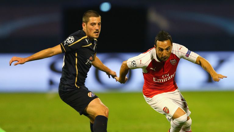 Arijan Ademi keeps track of Arsenal's Santi Cazorla 