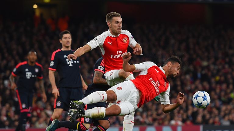 Francis Coquelin of Arsenal dives to head the ball clear ahead of team-mate Aaron Ramsey