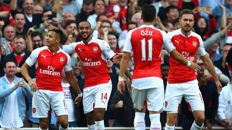 Alexis Sanchez (L) of Arsenal celebrates scoring their third goal with team mates during the Barclays Premier League match v Manchester United 