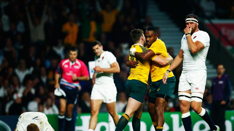 Chris Robshaw and Tom Wood of England react as Bernard Foley of Australia celebrates