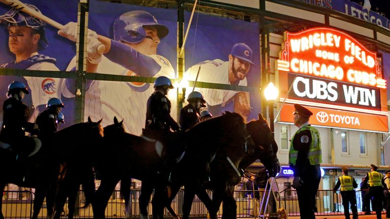 The Chicago Police Department Mounted Patrol Unit stands on Clark Street outside of Wrigley Field after the Chicago Cubs win