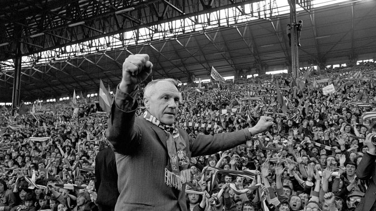Liverpool's legendary Bill Shankly.  Turning towards the Kop end of Anfield, Shankly gets an ovation from the fans who idolised him.