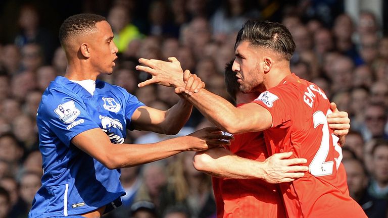James Milner (2R) holds Liverpool's Emre Can (R) back from Everton's Brendan Galloway 