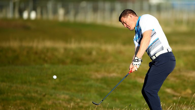 ST ANDREWS, SCOTLAND - OCTOBER 01:  Irish rugby legend Brian O'Driscoll chips onto the second green during the first round of the 2015 Alfred Dunhill Links