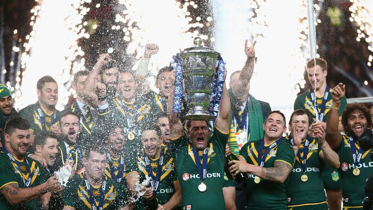 Cameron Smith, the captain of Australia, lifts the winners trophy after his sides 34-2 victory during the Rugby League World Cup