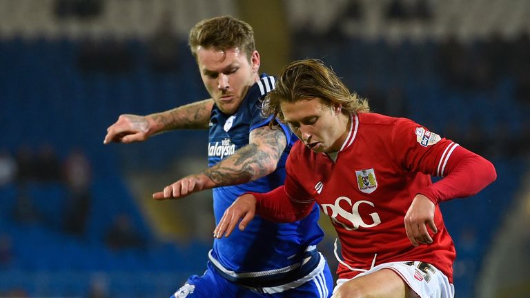 Bristol City's Luke Freeman holds off the challenge of Aaron Gunnarsson of Cardiff