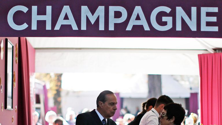 Racegoers enjoy champagne at Longchamp racecourse on October 04, 2015 in Paris