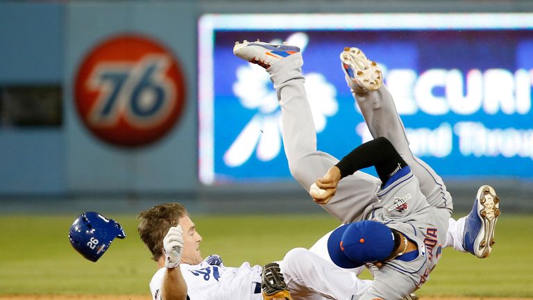 LOS ANGELES, CA - OCTOBER 10:  Ruben Tejada #11 of the New York Mets is hit by a slide by Chase Utley #26 of the Los Angeles Dodgers 