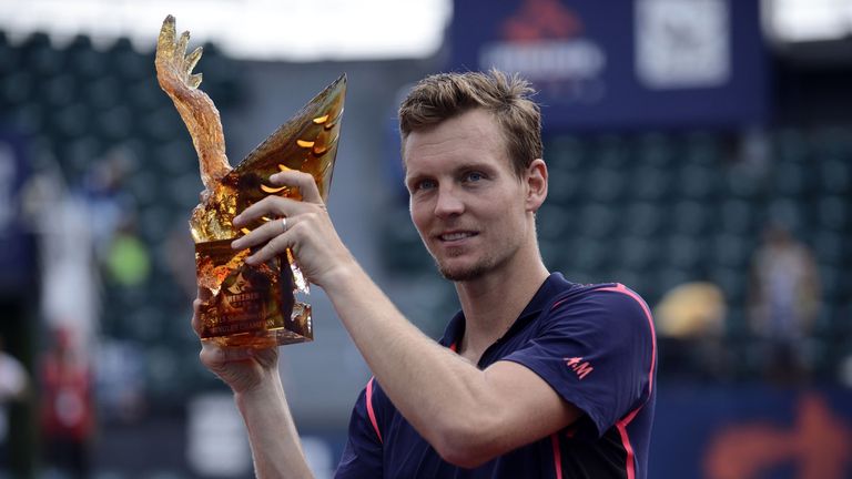 Tomas Berdych of the Czech Republic poses with the winner's trophy after beating Guillermo Garcia-Lopez of Spain in the men's singles final