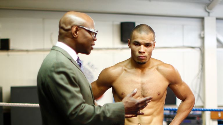 LONDON, ENGLAND - FEBRUARY 24:  Chris Eubank Jnr listens to father Chris Eubank after a media work out at the Peacock Gym on February 24, 2015 in London, E