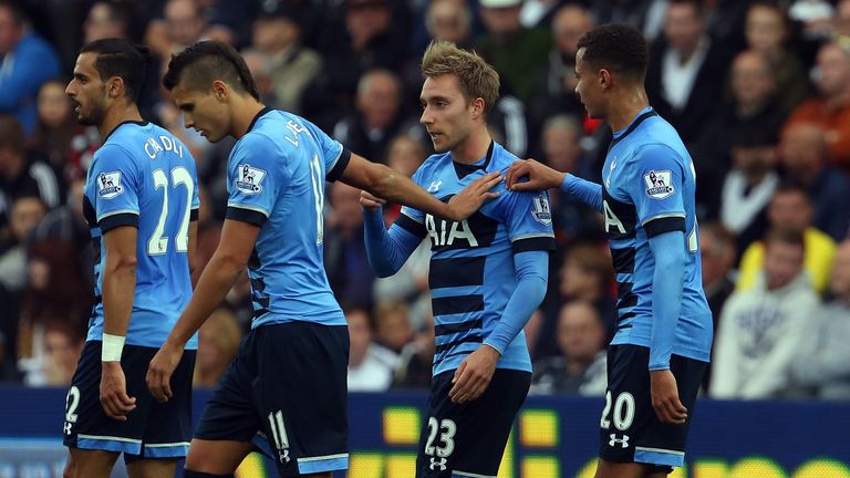 Tottenham players congratulate Christian Eriksen (second left) after his 25-yard free-kick leveled the score 1-1