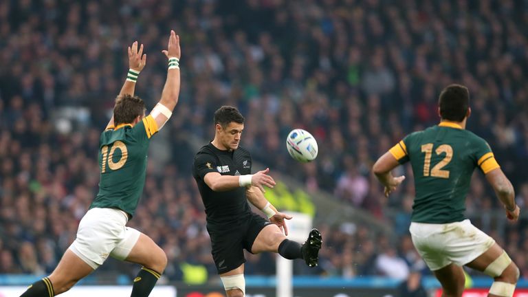 New Zealand's Dan Carter kicks the ball high away from the onrushing South Africa's Handre Pollard (left) during the Rugby World Cup, Semi Final at Twicken