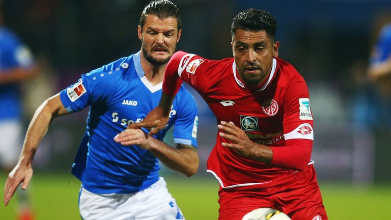 DARMSTADT, GERMANY - OCTOBER 02: Gonzalo Jara (R) of Mainz is challenged by Marcel Heller daa during the 