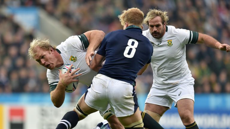 South Africa's Schalk Burger is tackled by Scotland's David Denton