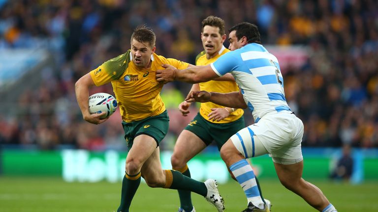 Drew Mitchell fends off Agustin Creevy during the 2015 RWC Semi Final between Argentina and Australia