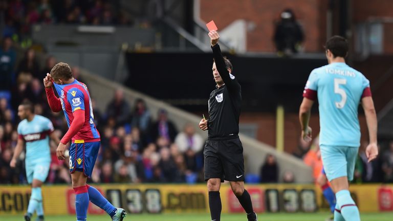 Dwight Gayle is shown a second yellow card for a late tackle on Cheikhou Kouyate