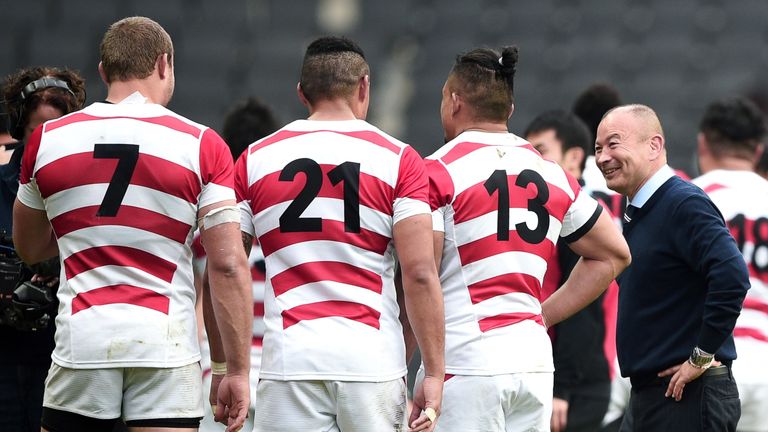 Japan coach Eddie Jones shares a joke with his players after beating Samoa