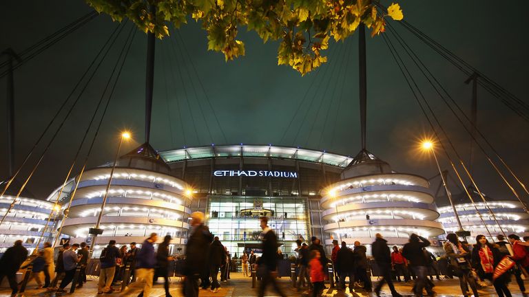 Fans walk outside the ground prior to the UEFA Champions League Group D match between Manchester City and Sevilla at Etihad